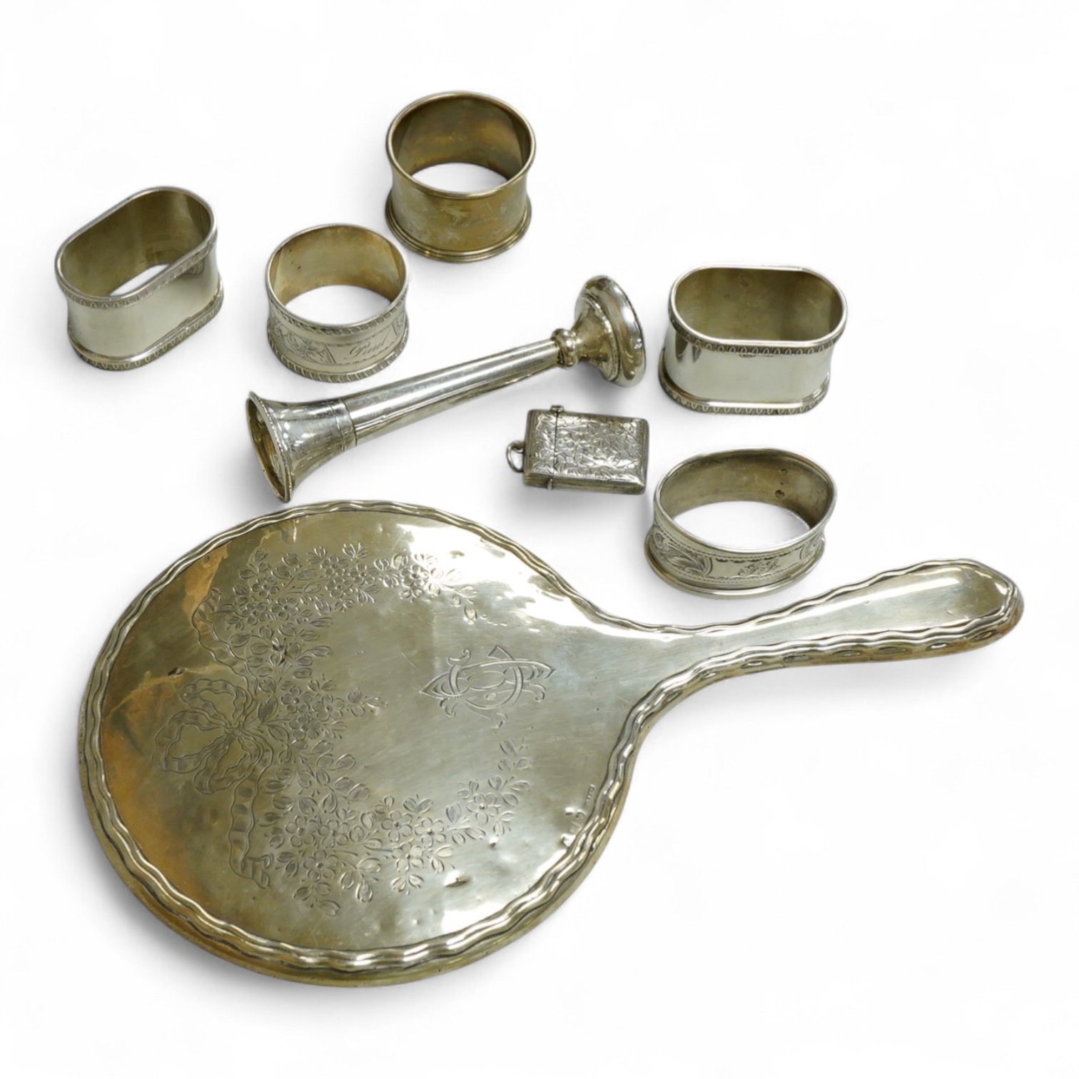 Three assorted silver napkin rings, a pair of recent 925 napkin rings, a George V silver mounted hand mirror, a modern silver mounted spill vase and a late Victorian silver vesta case.